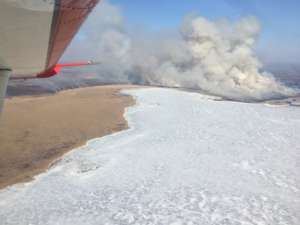 airplane approaching forest fire